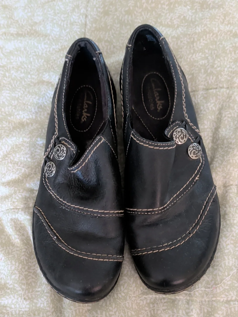 Clarks Black Slip-On Loafers with Silver Button Accent